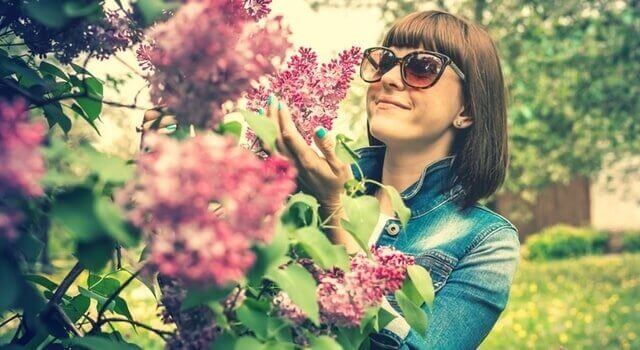 woman admiring flowers 640