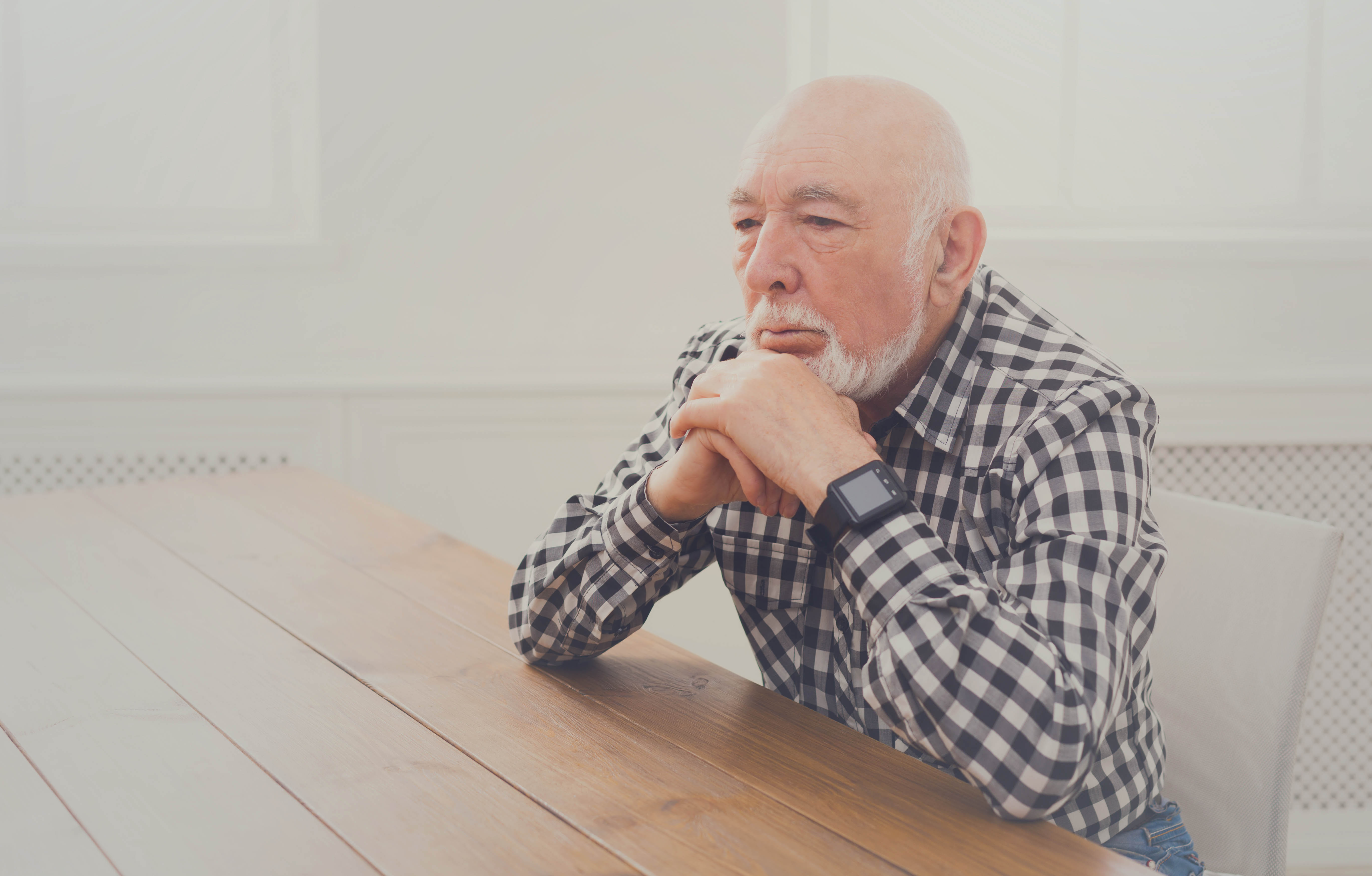 Senior Man Thinking at Table Thumbnail