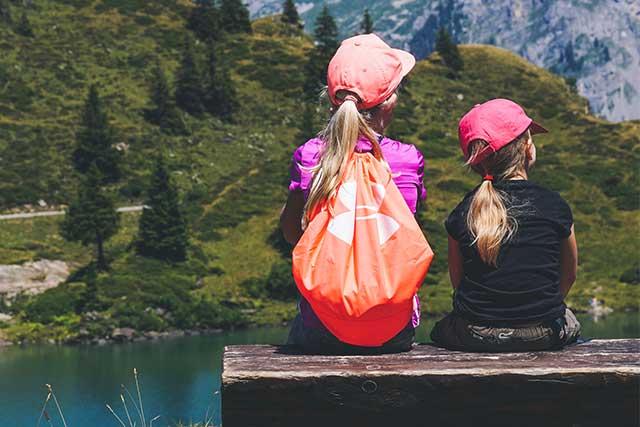 Sisters, resting on a hike, wearing contacts