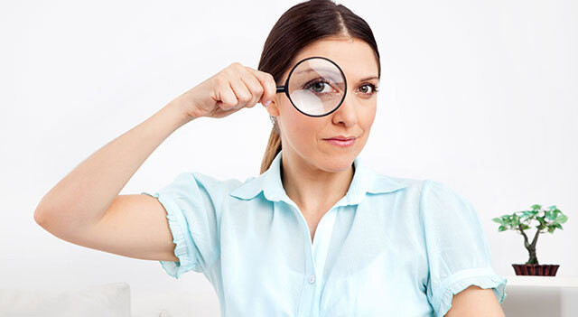 person looking through magnifying glass.jpg